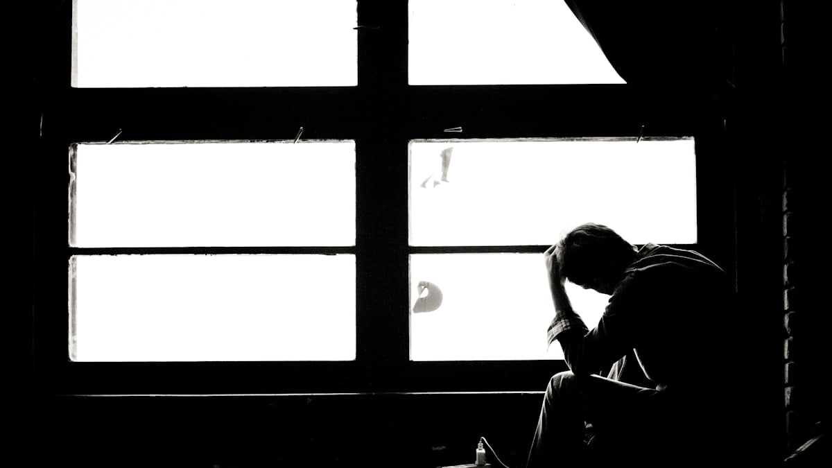 man and woman kissing in grayscale photography